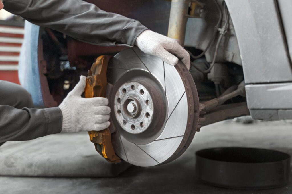 Brake disc and caliper exposed during a brake service
